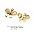 Golden bow pendant accessory made of copper and zircon showing front and back views - Bowknot (11)