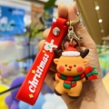 Close-up of a brown cartoon reindeer keychain with a red silicone strap for Christmas - Christmas Reindeer