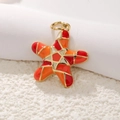 Macro shot of a red and orange enamel starfish pendant with golden plating and O-ring - A0176 Starfish (Red Enamel)
