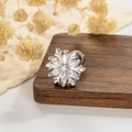 Silver snowflake stud earring with sparkling cubic zirconia on a rustic wooden base - Snowflake Style Single Piece (A1024-1)