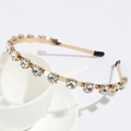 Slim gold metal headband featuring clear sparkling crystals with black anti-slip end caps - Clear Round Rhinestone