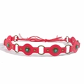 Detailed macro of red leather belt with turquoise stones and bronze ring accents - Bronze Rose Red