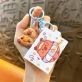 Cute cartoon Capybara keychain set featuring a brown 3D figure and blue ring bag charm - Magic Box - Blue