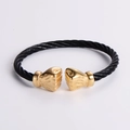 Detail of twisted black cable bracelet featuring gold boxing glove ends in hip hop style - Black & Gold