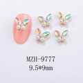 Macro view of 3D aurora butterfly nail art charms with white pearls in 9.5x9mm size - Aurora Pearl Gold Base Style (MZH-9777)
