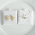 Macro detail of pearl necklace and flower studs on premium white textured display card - 6*6cm / White