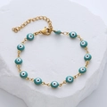 Close-up of gold stainless steel evil eye bracelet with blue enamel beads and lobster clasp - Emerald Green