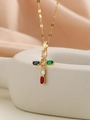 Macro detail of gold cross pendant necklace featuring inlaid multi-colored cubic zirconia - Gold Multi-color Zirconia (5 Ovals)