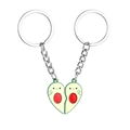 Detail of magnetic avocado couple keychains forming a heart shape in green and red - Cartoon Avocado