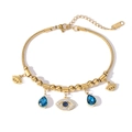 Detailed macro view of gold evil eye bracelet with blue crystals and steel hallmark - Gold Round Eye Water Drop Style