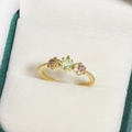 Gold flower ring with square green gemstone and purple accents in a jewelry box - Square Light Green Gemstone Flower Shaped Ornament Style (金色29)