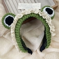 Green knitted frog headband with white lace trim and large cartoon eyes - Lace Style / Green
