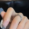 Close-up of a silver zircon open ring with double-row crystals worn on a finger - Open Double Row Zircon (HR788)