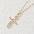 Golden cross necklace with sparkling white zircons on a textured white background - Gold Marquise Round Alternate (0100R)