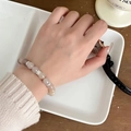 Beaded natural agate stone bracelet with silver floral spacers on a female wrist - Mixed Cat's Eye Stone Beads Bracelet
