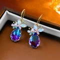 Detail view of gold earrings with butterfly zircon and waterdrop-shaped blue gradient gemstone - Purple Butterfly Water Drop Ear Hook