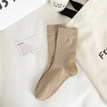 Minimalist khaki mid-calf cotton socks with ribbed texture in a lifestyle display - Coarse Rib / Light Coffee