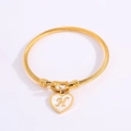 Golden twisted rope bangle with heart pendant and letter H on white background - Letter H
