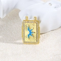Macro view of a gold tarot pendant with blue sunbeam and crystal border on stone - Blue Sun Style (ZYN-DMK871G-2)