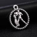 Macro view of a vintage silver-colored zodiac pendant with an embossed male silhouette - Style 5 / Antique Silver