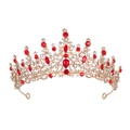 Macro shot of Baroque gold tiara featuring sparkling red rhinestones and hollow patterns - Red