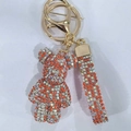 Sparkling rhinestone bear keychain in orange and white with matching braided wrist strap - Mixed Coral Red