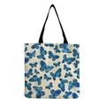 Close-up of beige tote bag with blue butterfly print and black canvas handles - Dense Blue Butterflies (hm2718)
