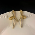 Elegant gold bow earrings with crystal pavé setting shown on a white ceramic tray - 21#E5273 Silver Pin-Gold