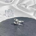Detailed close-up of a silver snake-shaped ring on black stone with white silk background - Style 3 Adjustable Ring