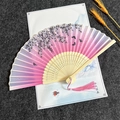 Chinese folding fan with pink gradient floral patterns and carved bamboo ribs with tassel - Cherry Blossoms Falling - Pink