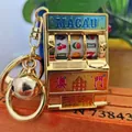 Golden Macau slot machine keychain with a lucky bell and rotating fruit symbols - Macau Golden Buckle And Golden Bell / 1000 Minimum Order