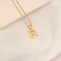 Golden stainless steel necklace featuring a textured letter R pendant with box chain - Letter R