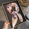 Lavender silk-feel scarf with colorful floral print folded in a lifestyle display - 70*70cm / 30310-Lavender Abstract Floral