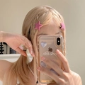 Pink star-shaped hair clip worn on blonde braided pigtails for a sweet look - Pink Star Style (1304C2)