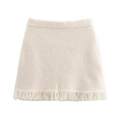 Minigonna chic in maglia crema con texture peluche e dettagli sfrangiati fitti - S / Minigonna