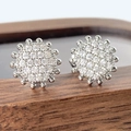 Sparkling silver round stud earrings with pavé cubic zirconia on wooden display stand - Silver