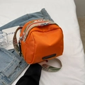 Orange nylon shell crossbody bag featuring a colorful floral patterned wide strap - Orange