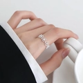 Elegant hollow floral open ring in silver finish worn by a model for a stylish look - Silver