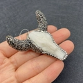 White bull skull pendant with dark grey rhinestones held in hand for size reference - White Body + Dark Grey Rhinestones