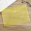 Translucent yellow A4 file folder with white snap button closure on dark wood desk - 18 Microns Yellow Plain