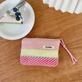 Colorful striped woven makeup bag with vibrant pink, yellow, and blue geometric textures - Red & Pink Stripes