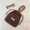 Brown wool drawstring pouch bag with white polka dots and woven carry handles - Brown