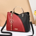 Women's two-tone handbag in red and black with golden handles and heart pearl tassel - Black and Red