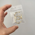 Golden twisted hoop earrings packaged in a portable transparent jewelry storage bag - 25 Micron 6x8.5cm Perforated Resealable / 100 Pcs/Pack