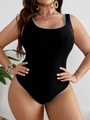Detail view of plus-size one-piece swimsuit featuring vibrant scalloped trim and black fabric - XL / Black