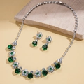 Detailed view of emerald green zircon flower necklace and earrings in silver finish - Green