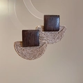 Detail of bohemian raffia fan earrings featuring square wood studs on a warm background - Dark Brown (Silver Needle)