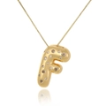 Macro shot of 18k gold plated letter F pendant with zircon stones and polished finish - Letter F