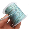 Macro shot of multi-color braided cotton cord roll for DIY jewelry and bracelets - Approx. 2.0mm / Blue, Pink, Yellow and Green