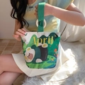 Off-white canvas bucket bag featuring a green panda print and green ribbon handles - Forest Bear